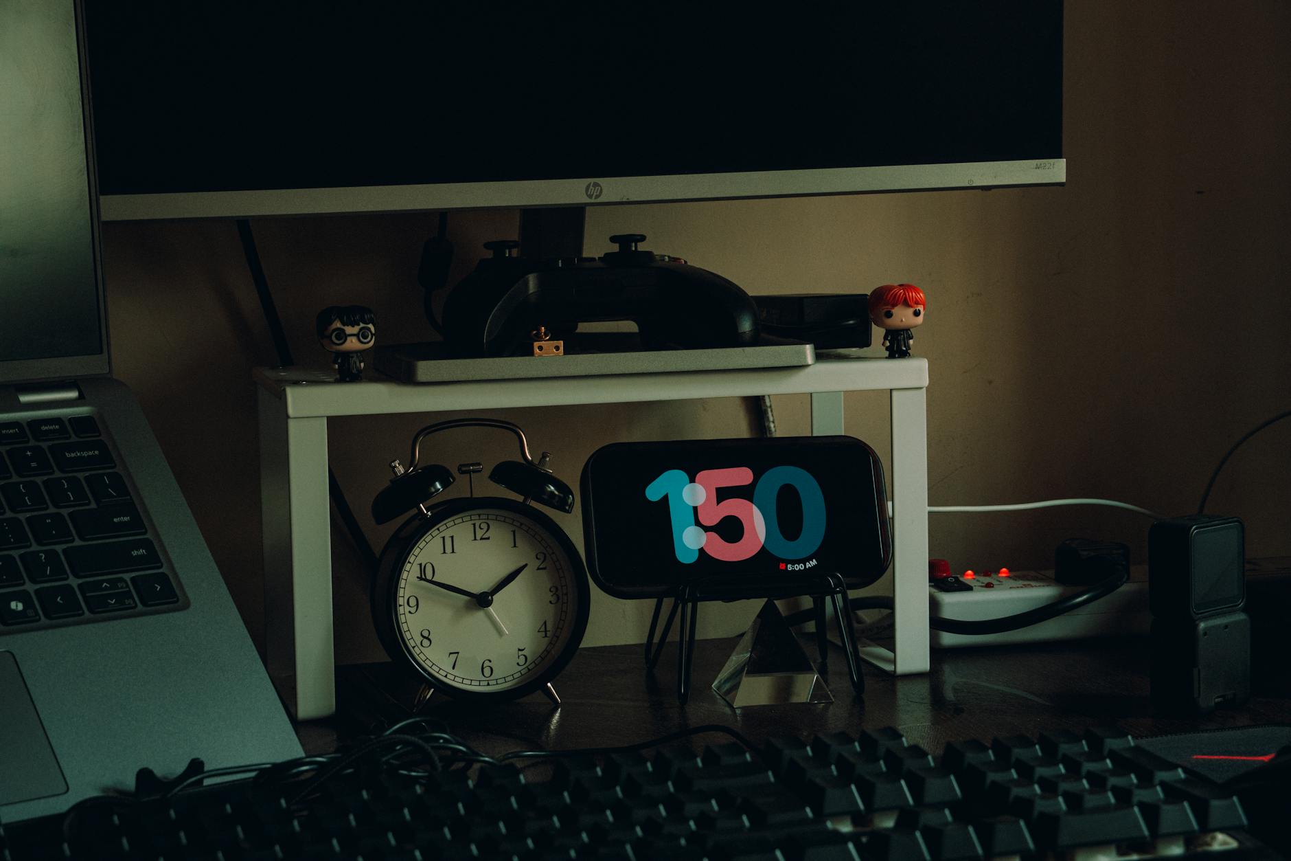 teen using gaming laptop at desk with RGB keyboard and headphones