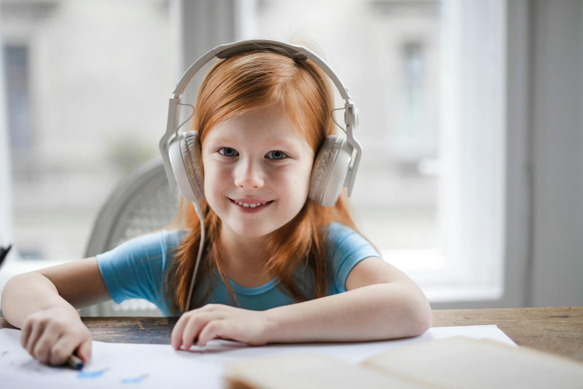 child wearing colorful over-ear headphones outdoors during summer